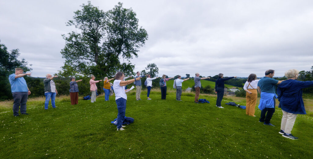 June leads a Celtic directional prayer on the ceremonial mound at Navan Fort in Armagh.